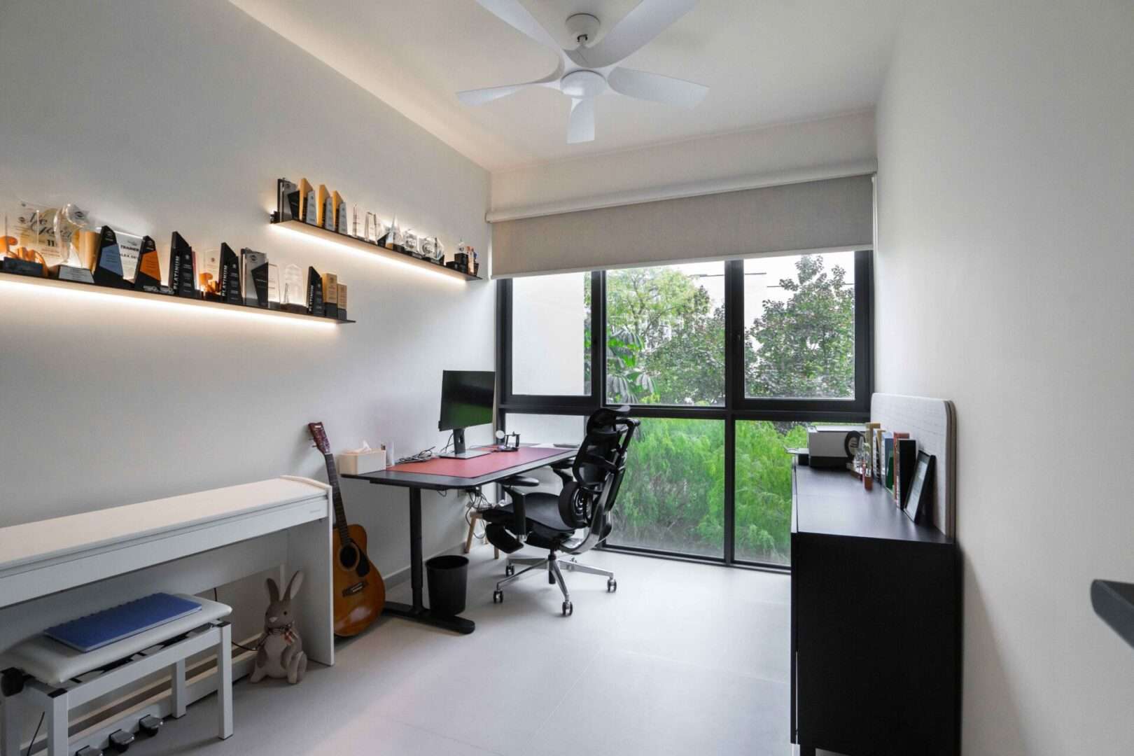 Home office with study desk, ergonomic chair and display shelves