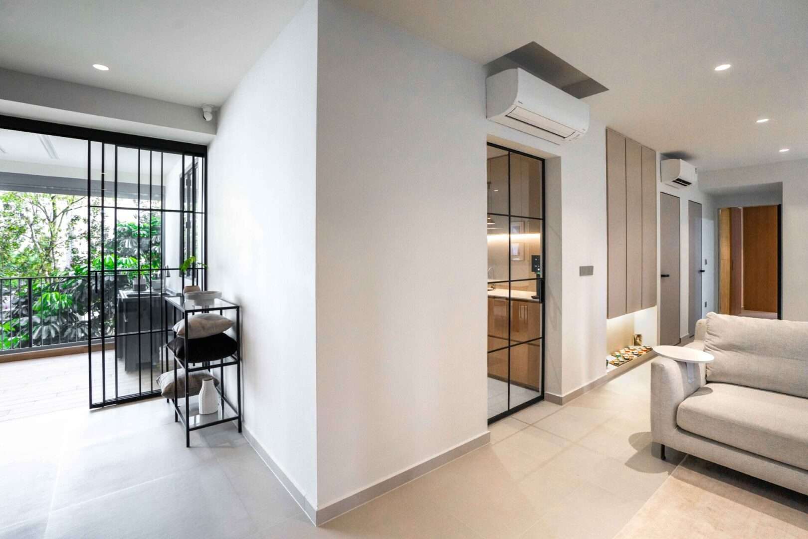 Secondary angle showing corridor, slim-frame doors and living area